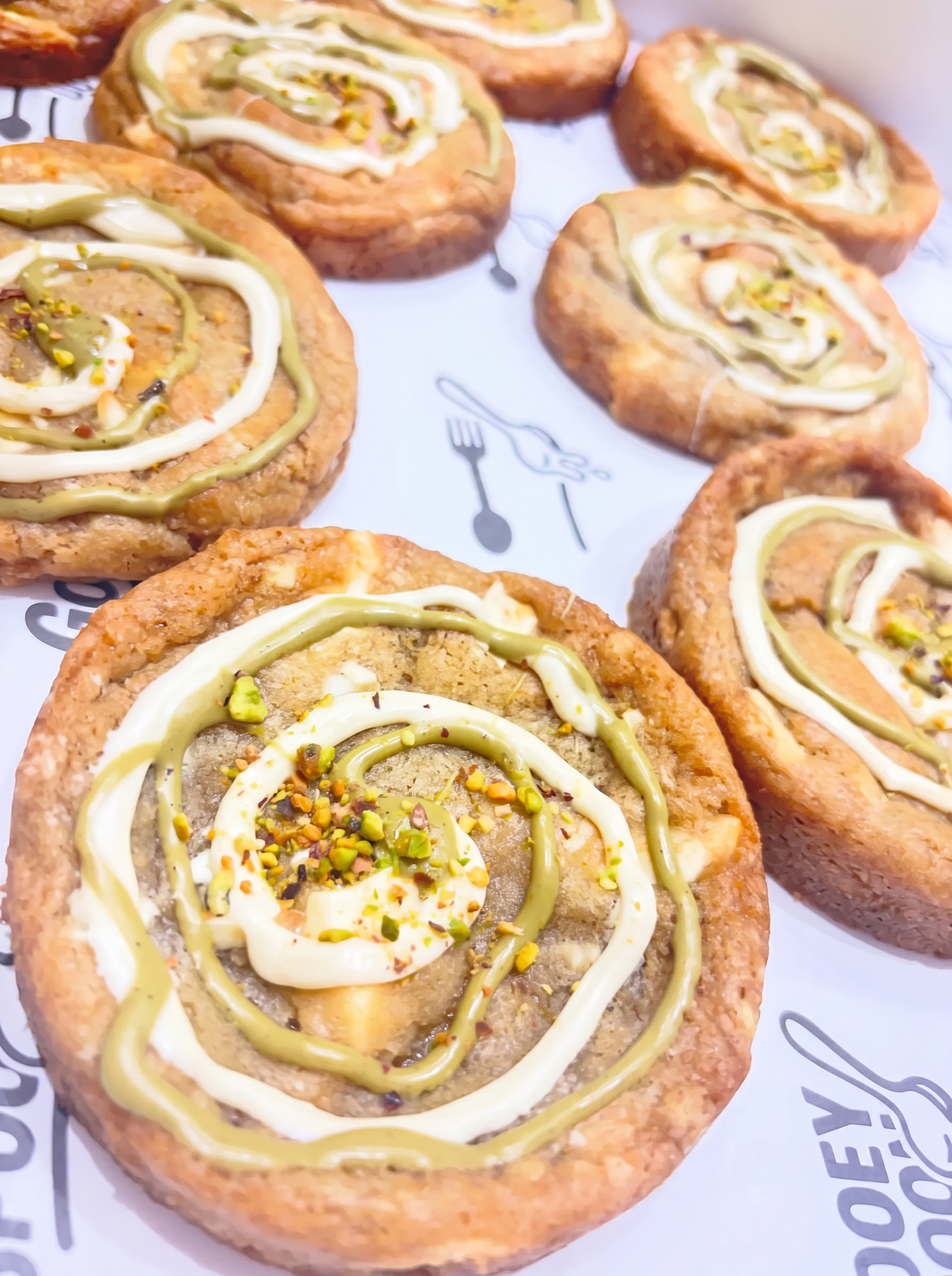 Pistachio and white chocolate cookies on Gooey Spoon branded paper