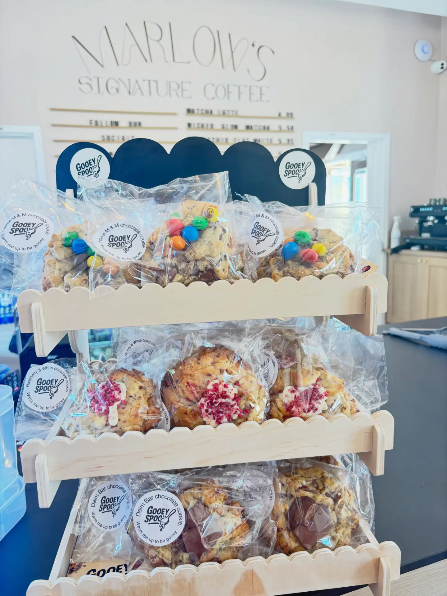 Gooey Spoon cookies bagged on a café display shelf